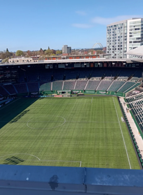 This image shows a lively soccer match at Providence Park in Portland. The stadium is filled with passionate fans cheering for the local teams, creating an exciting atmosphere for every game.