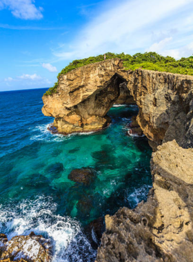 This image shows the ancient carvings at Cueva del Indio, with petroglyphs etched into the stone. The ocean waves crashing against the rocks add to the mystery and beauty of the location, showcasing Puerto Rico’s indigenous Taino history.