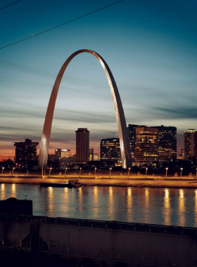 "This image shows the towering Gateway Arch with the St. Louis skyline in the background, capturing the iconic landmark that symbolizes America’s westward expansion. The surrounding park with greenery is also visible, showcasing the area’s spacious and scenic landscape."