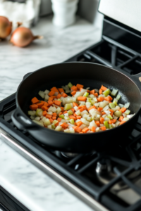 sauteing-onions-carrots-celery-for-creamy-chicken-noodle-soup