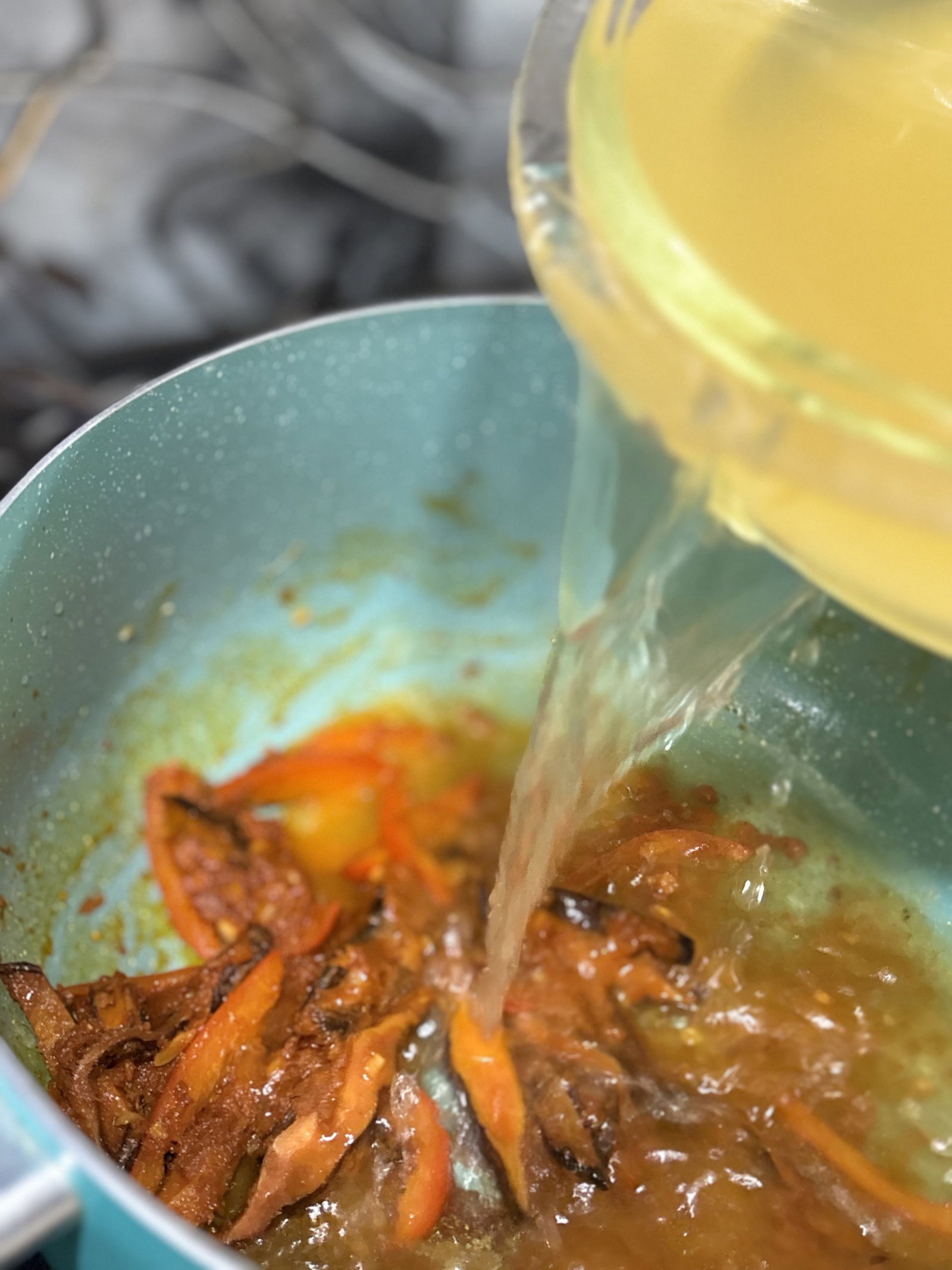 Add the chicken broth and stir until the curry paste dissolves.