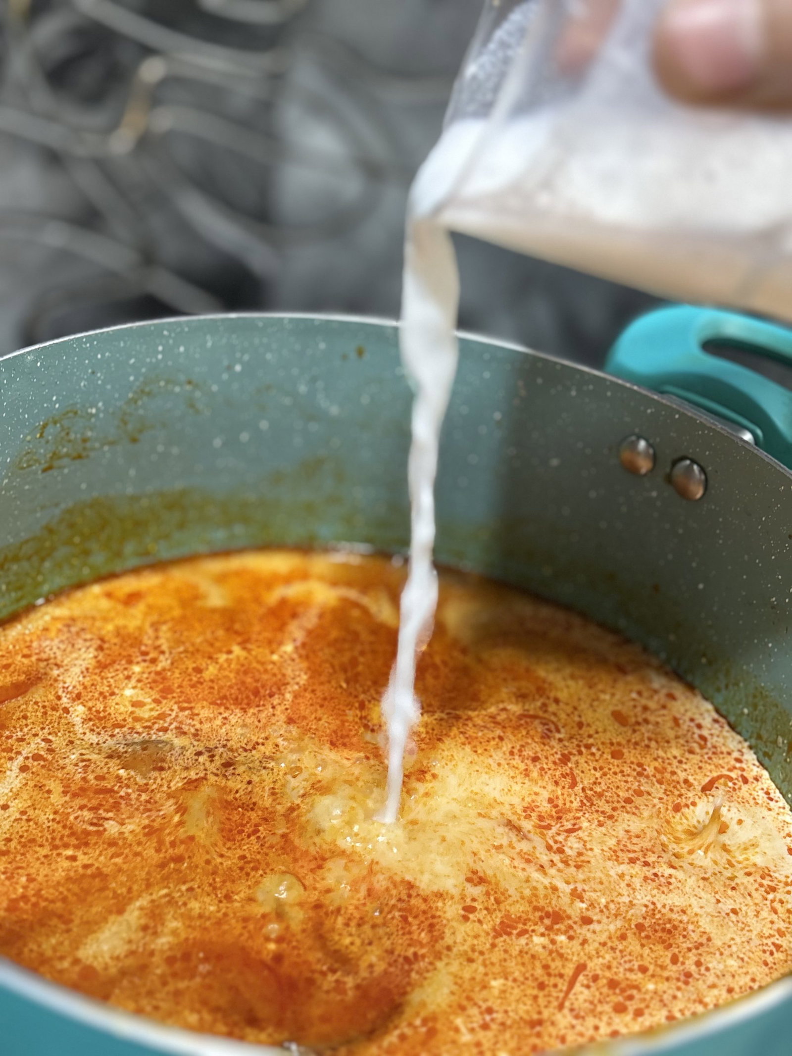 Lower the heat and stir in the coconut milk so the soup turns creamy