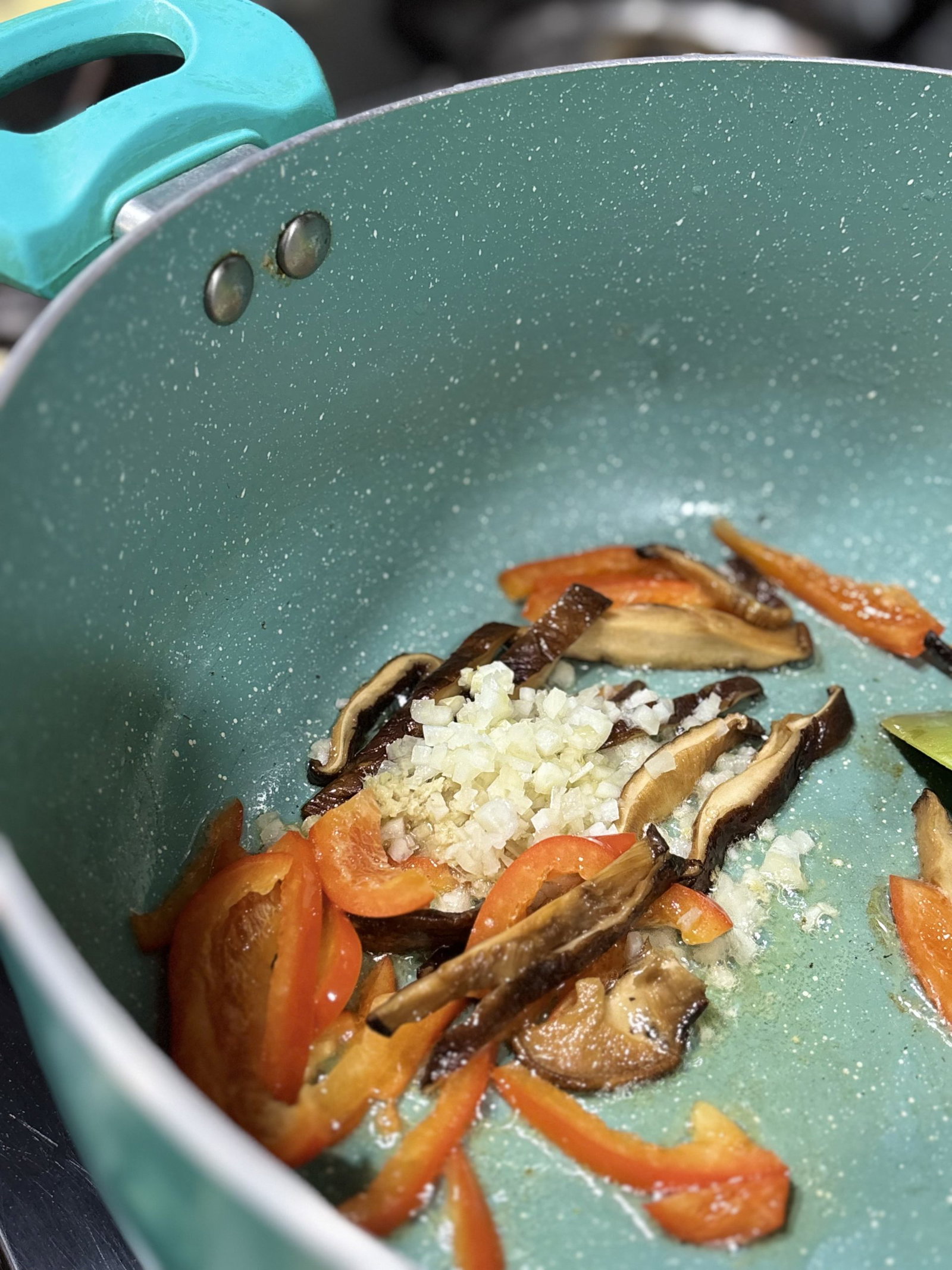 Sauté the onion, garlic, bell pepper, and ginger until they soften and smell warm.