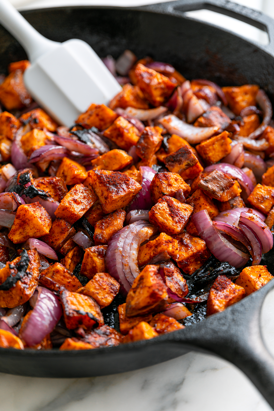 In different skillet, add the sweet potatoes and sliced onions and cook them for about 8–10 minutes.
