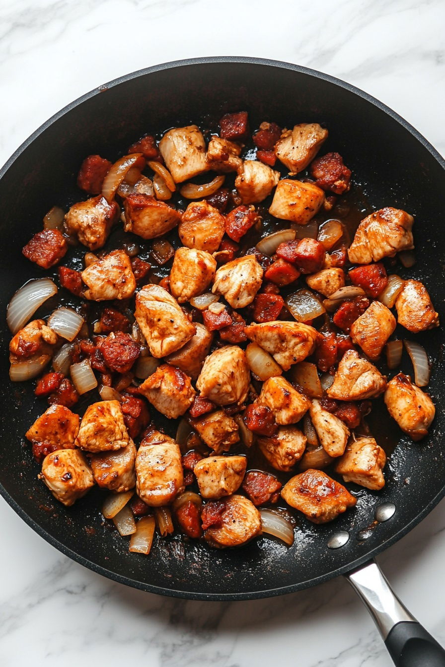 Add marinated chicken and cook until lightly browned.