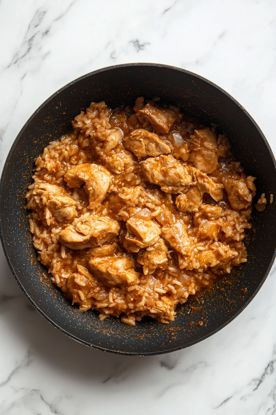 Mix in garam masala and soaked rice. Pour water, cover, and cook on low heat.