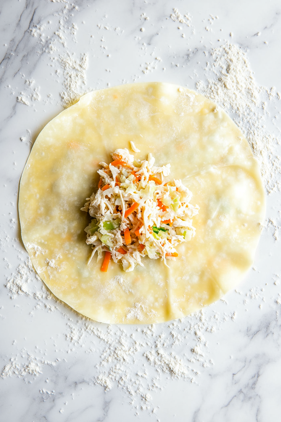 Place 2 tablespoons of filling on each egg roll wrapper.