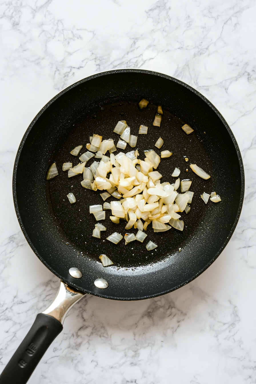 Heat oil in a pan, add chopped garlic and onions. Sauté until golden.