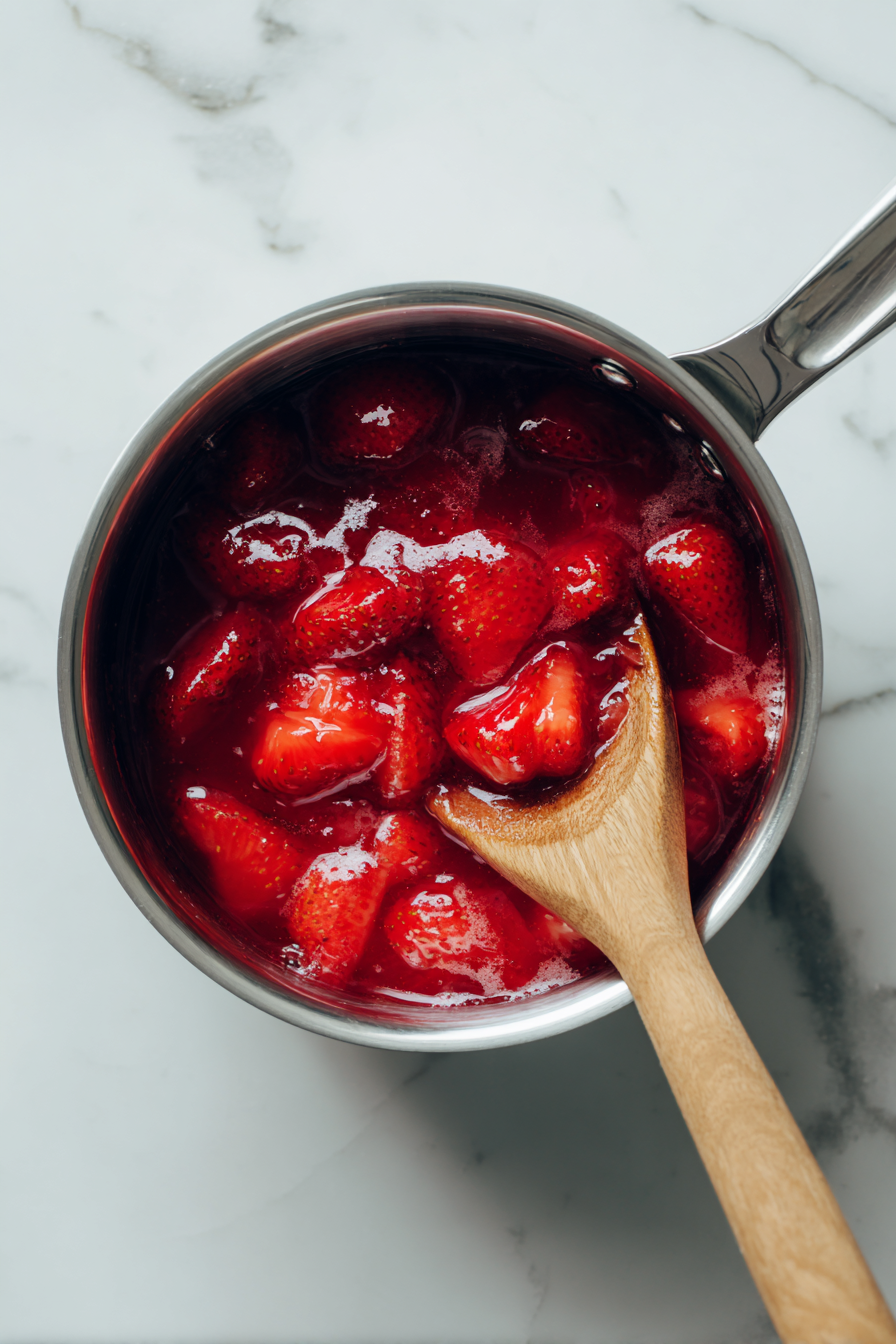 For topping, simmer strawberries, water, sugar, lemon juice, and cornstarch until thickened. Cool, then spoon over cheesecake before serving.