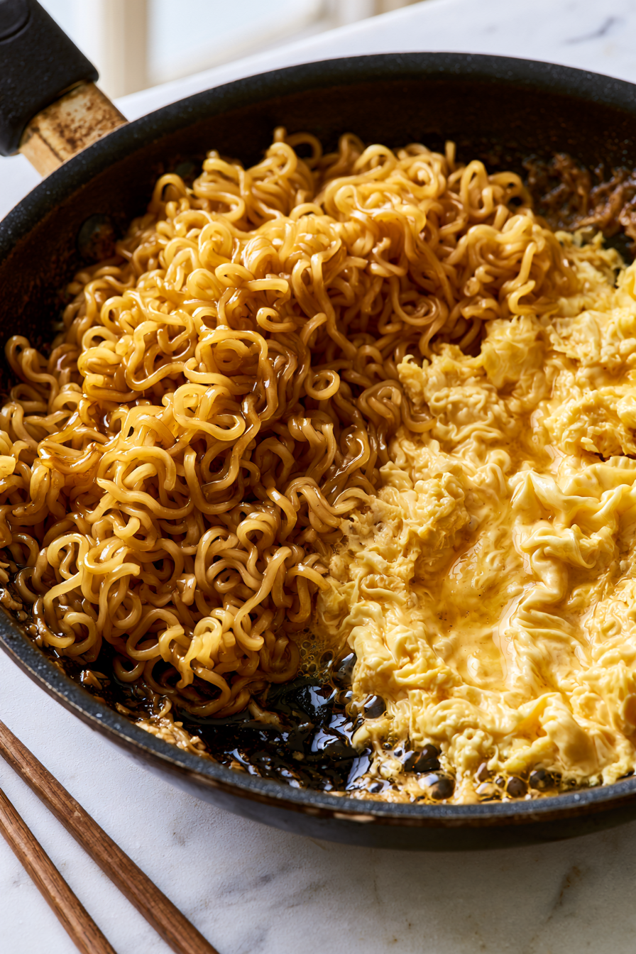 Push noodles to one side, crack the egg in, and stir quickly