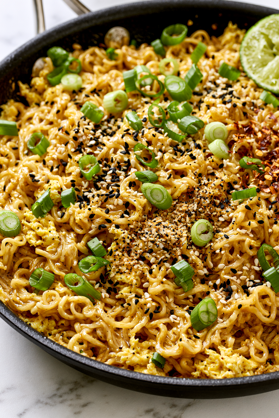 Turn off the heat. Add a squeeze of lime, toss again, and top with sesame seeds and green onions.