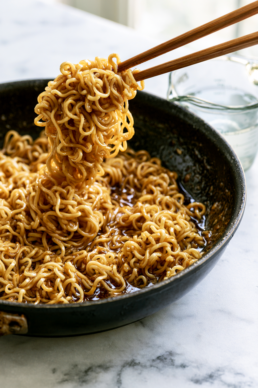 Use tongs to swirl the noodles through the glossy sauce until every strand shines