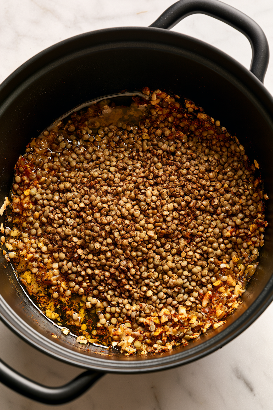 Add the rinsed lentils to the pot and stir to coat with the spice mixture and vegetables