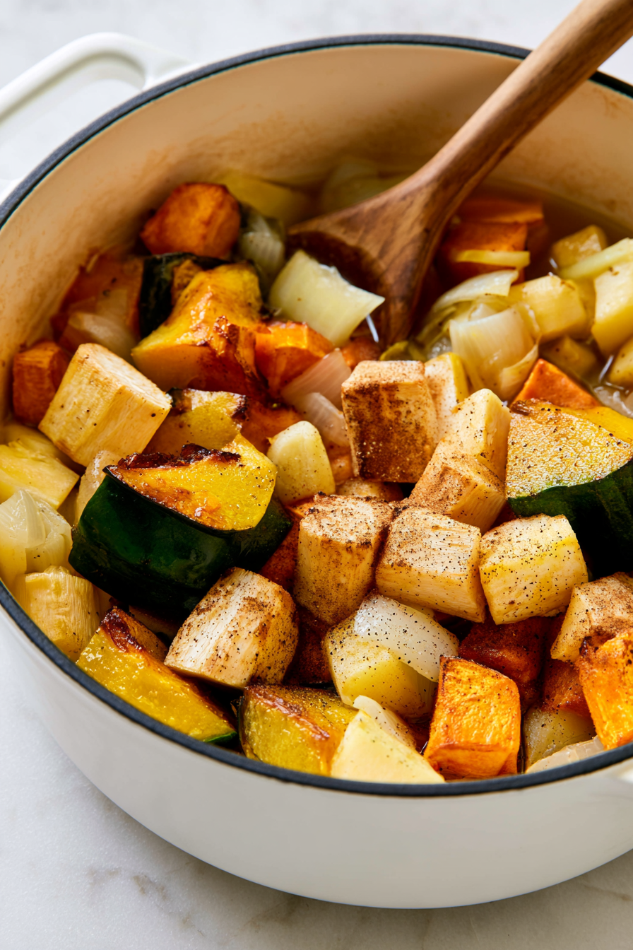 Add the roasted vegetables to the pot, then pour in the vegetable stock