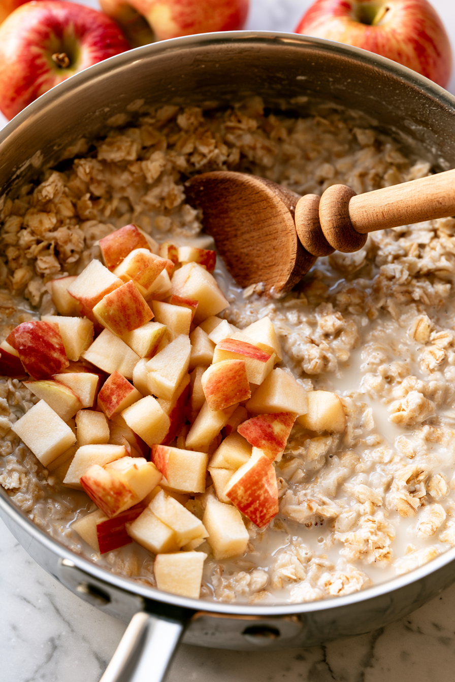 Chop the apple into small, even pieces and add them to the oats, stirring to distribute evenly
