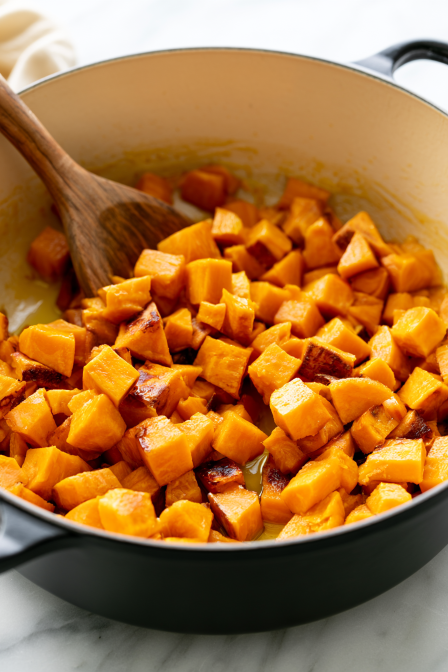 Heat olive oil in a large pot over medium heat. Add the chopped sweet potatoes and cook, stirring occasionally, until they start to soften and develop some color, about 8 minutes