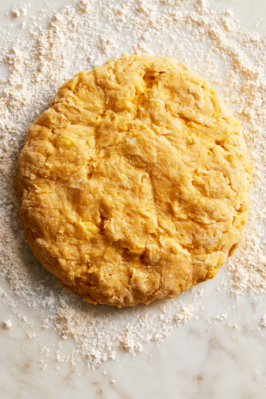 Turn the dough onto a lightly floured surface and knead it gently a few times to bring it together into a rough disk