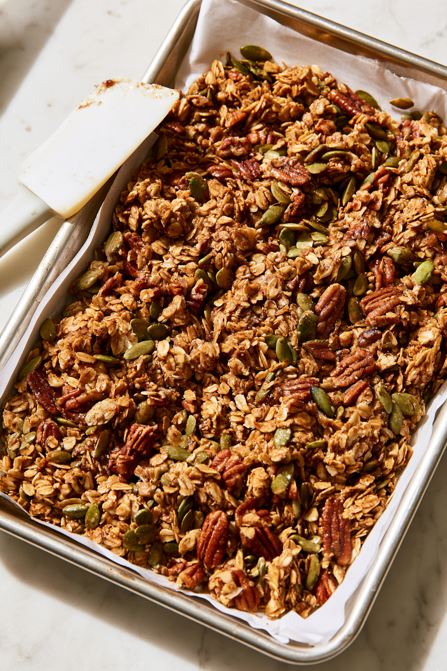 Spread the coated mixture onto the prepared baking sheet, pressing down gently to form an even layer