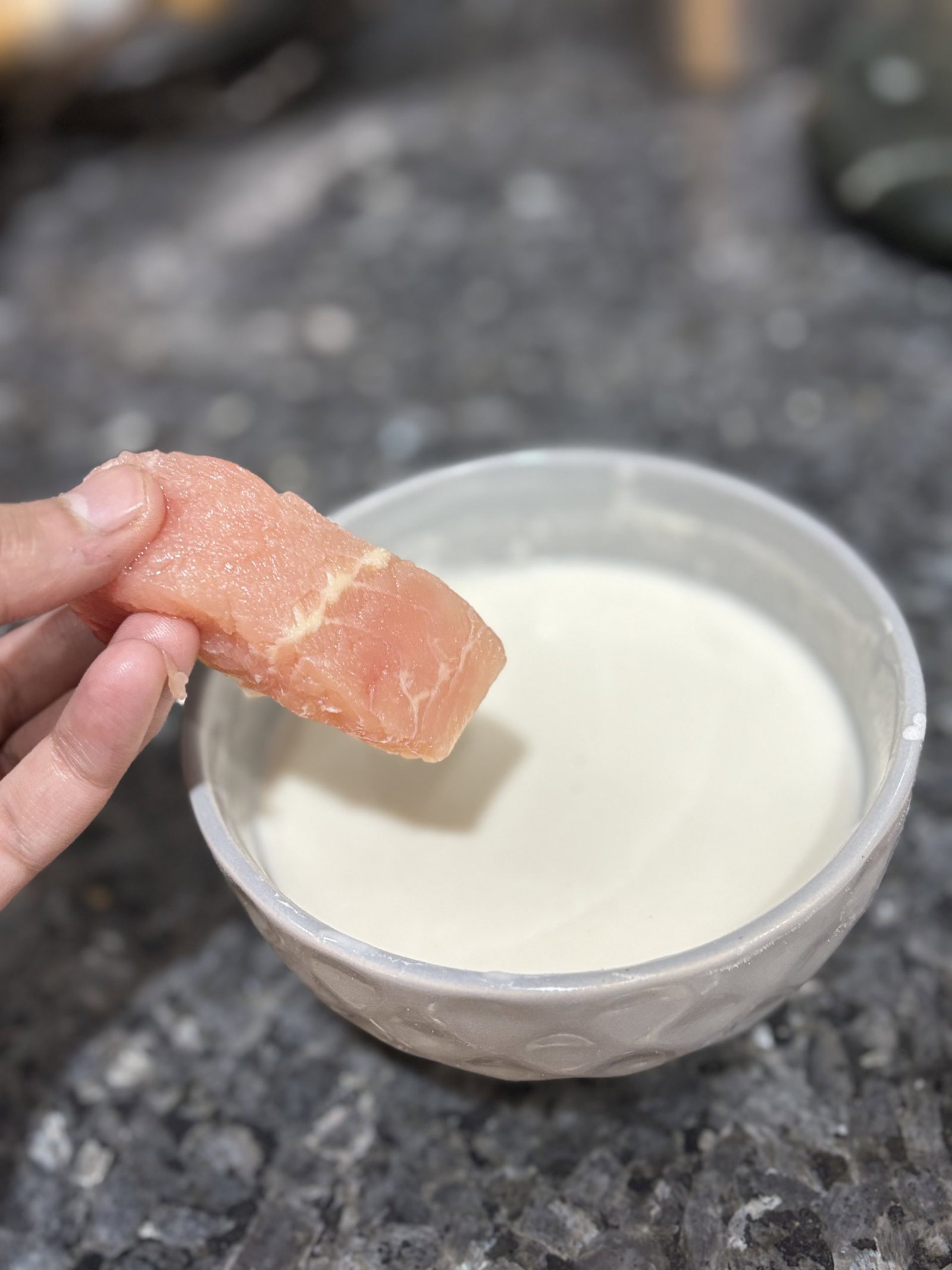 Dip fish filets into the batter, coating them entirely to create an even layer