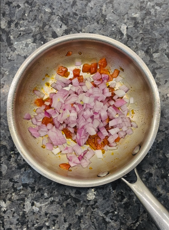Heat oil in a small pan over medium heat, then add onion and tomatoes, sprinkle with salt, and cook for 4 minutes