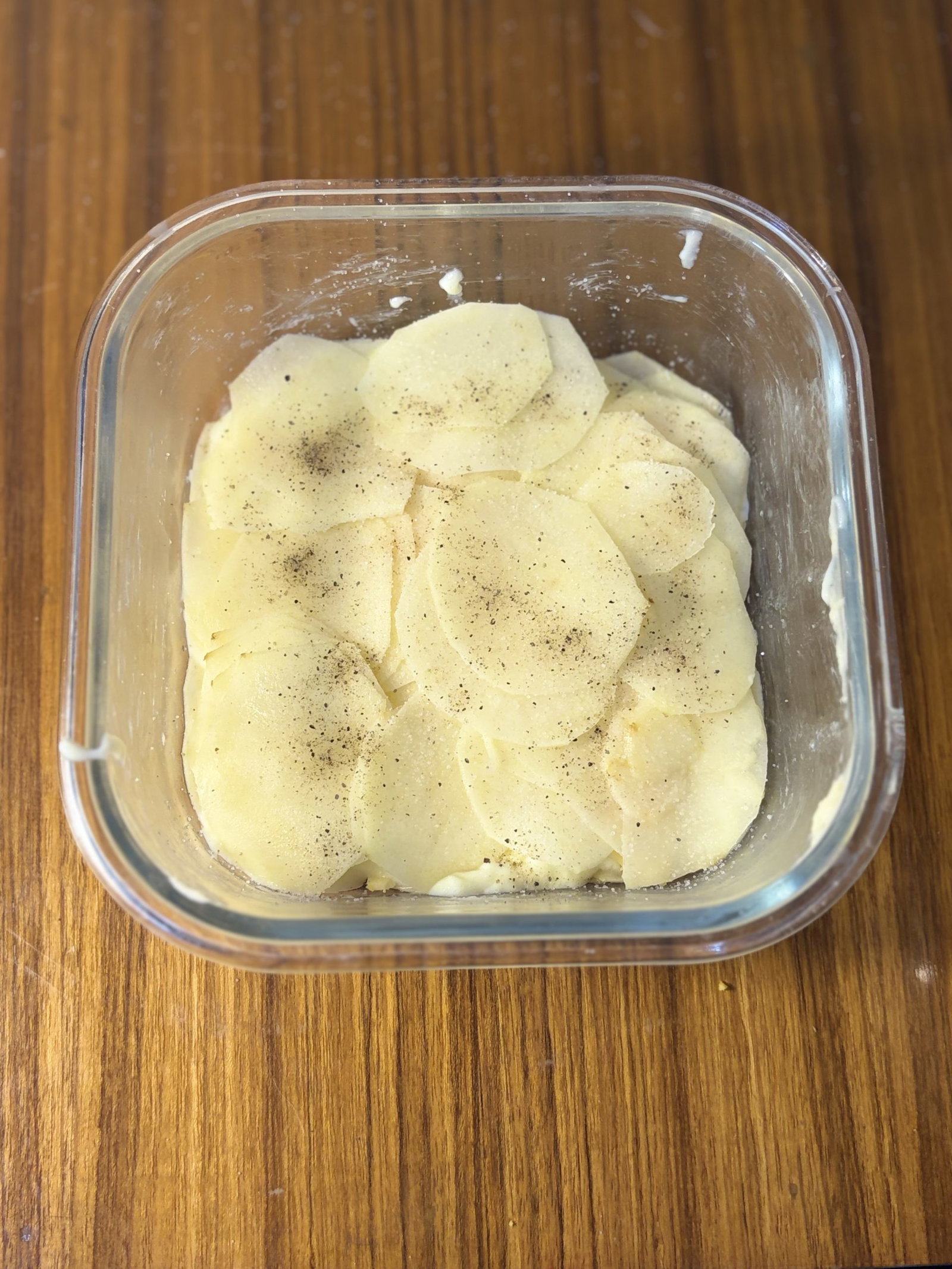 Layer the remaining potatoes and onions, seasoning again lightly with salt and pepper.