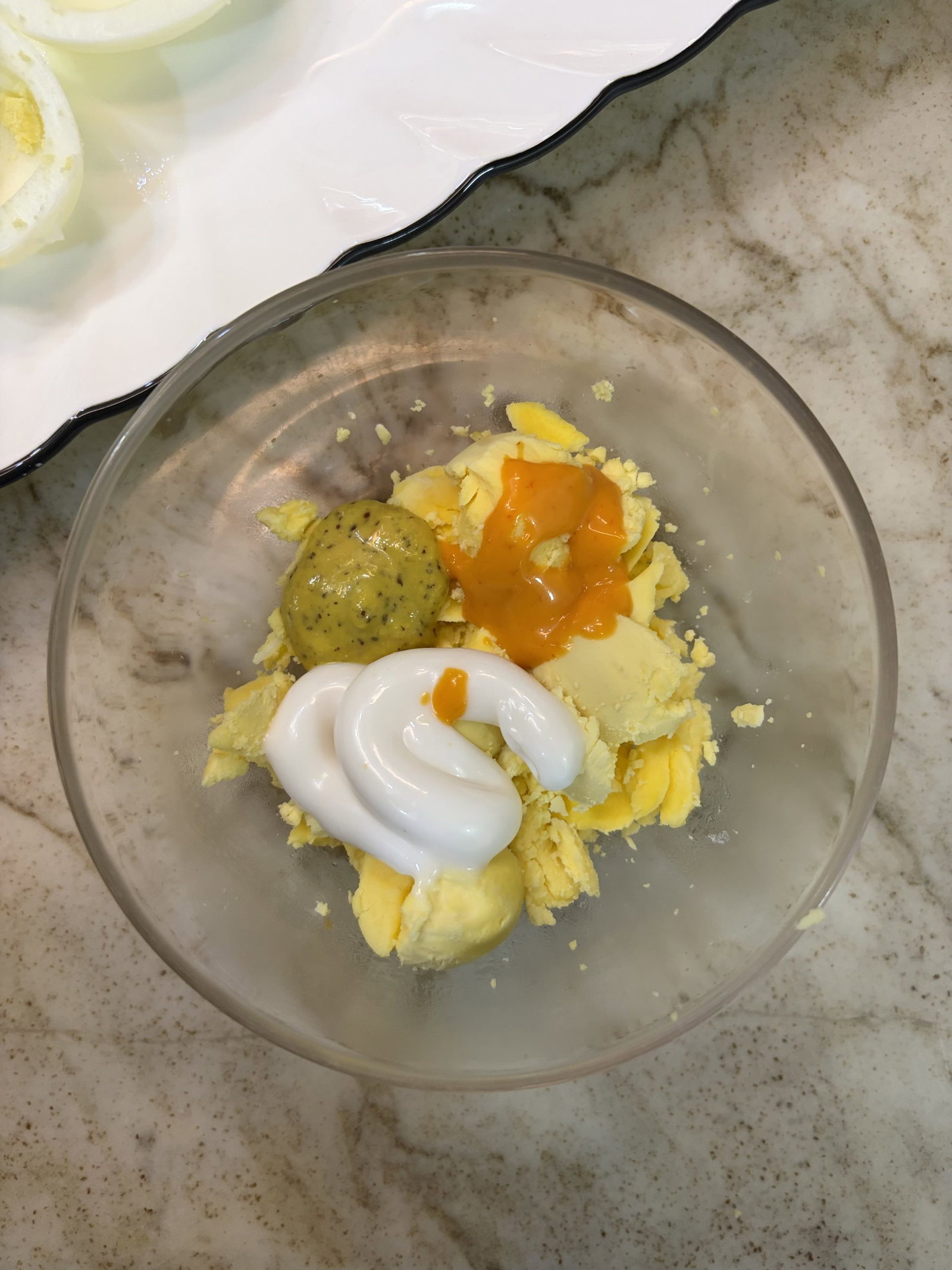 Mash the yolks with mayonnaise, pickle relish, and mustard until smooth