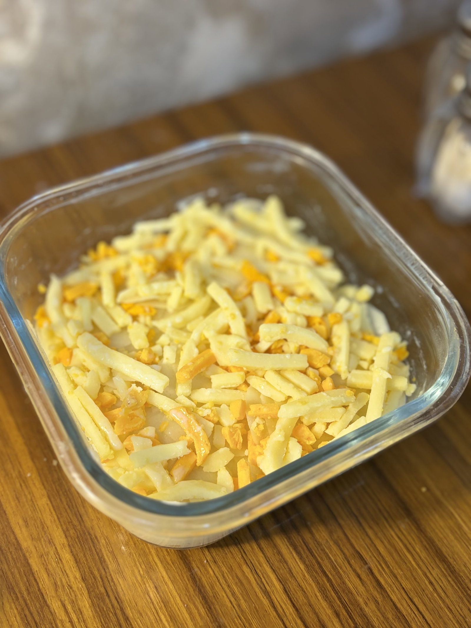 Pour the warm cheese sauce evenly over the layered potatoes, making sure it seeps down between the layers.