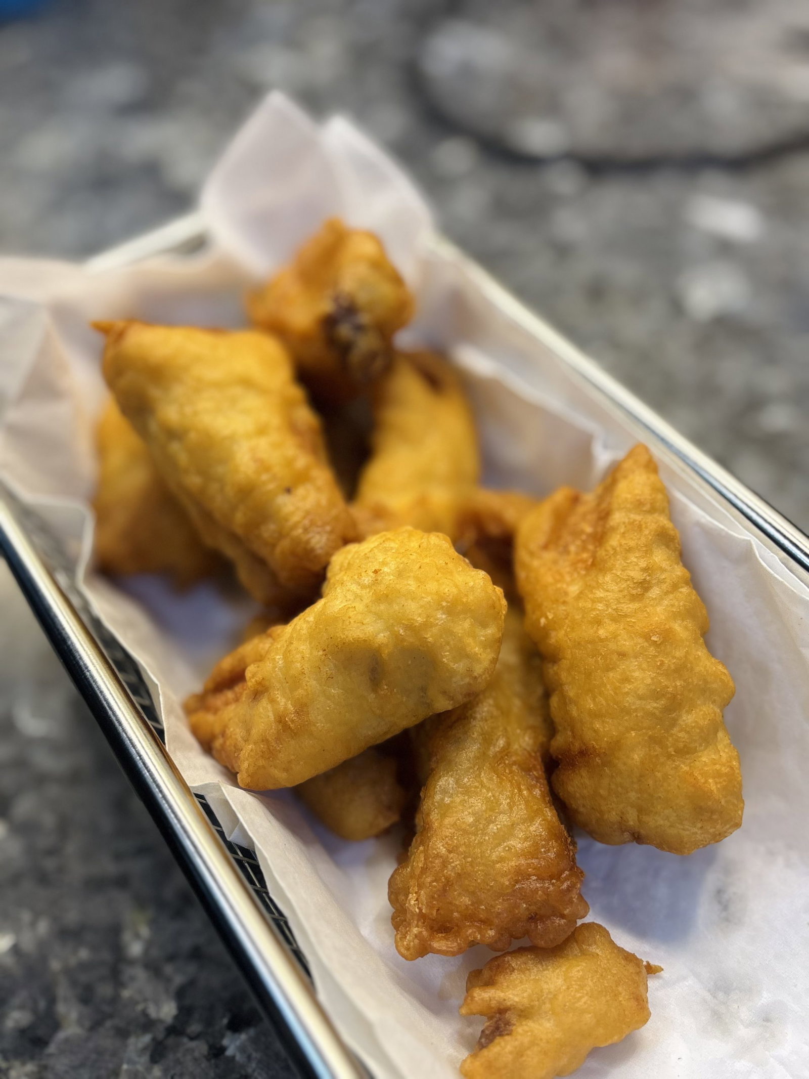 Remove from the oil using tongs and transfer to a paper towel-lined plate to drain excess oil before serving hot