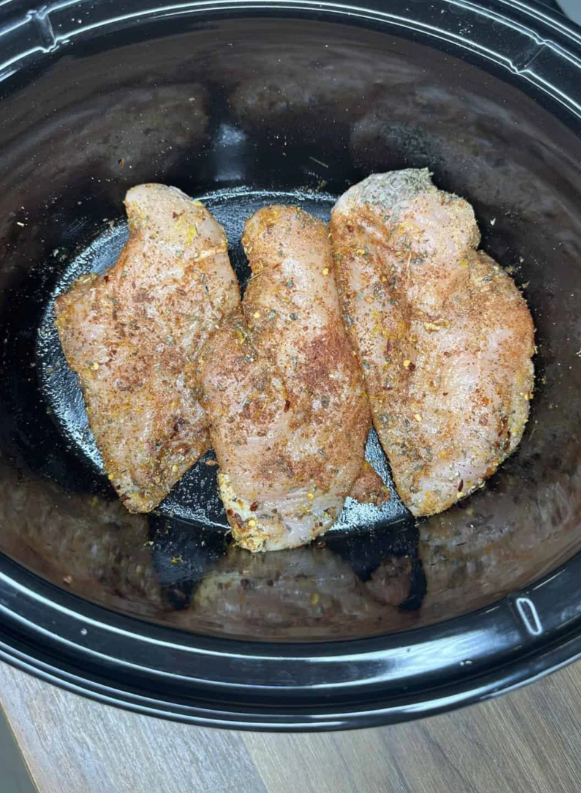 Spray the crockpot with nonstick cooking spray. Layer the seasoned chicken breasts in the bottom of the crockpot