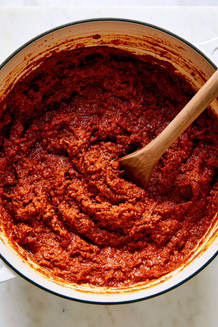 Add the tomato paste, garam masala, cumin, coriander, paprika, turmeric, cayenne, salt, and black pepper