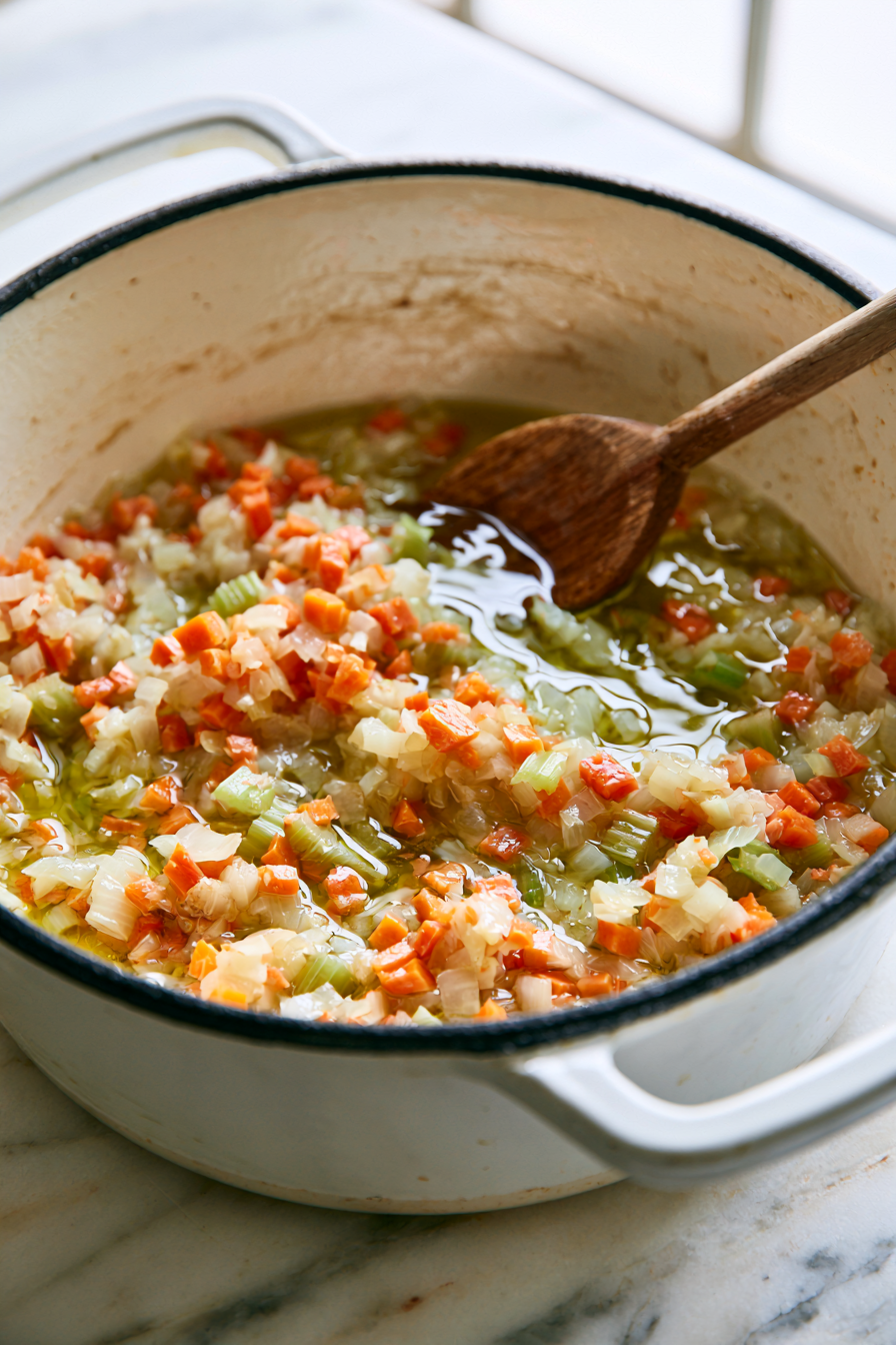 Heat the olive oil in a large Dutch oven over medium heat. Add the onion, carrots, and celery. Cook for 8 to 10 minutes