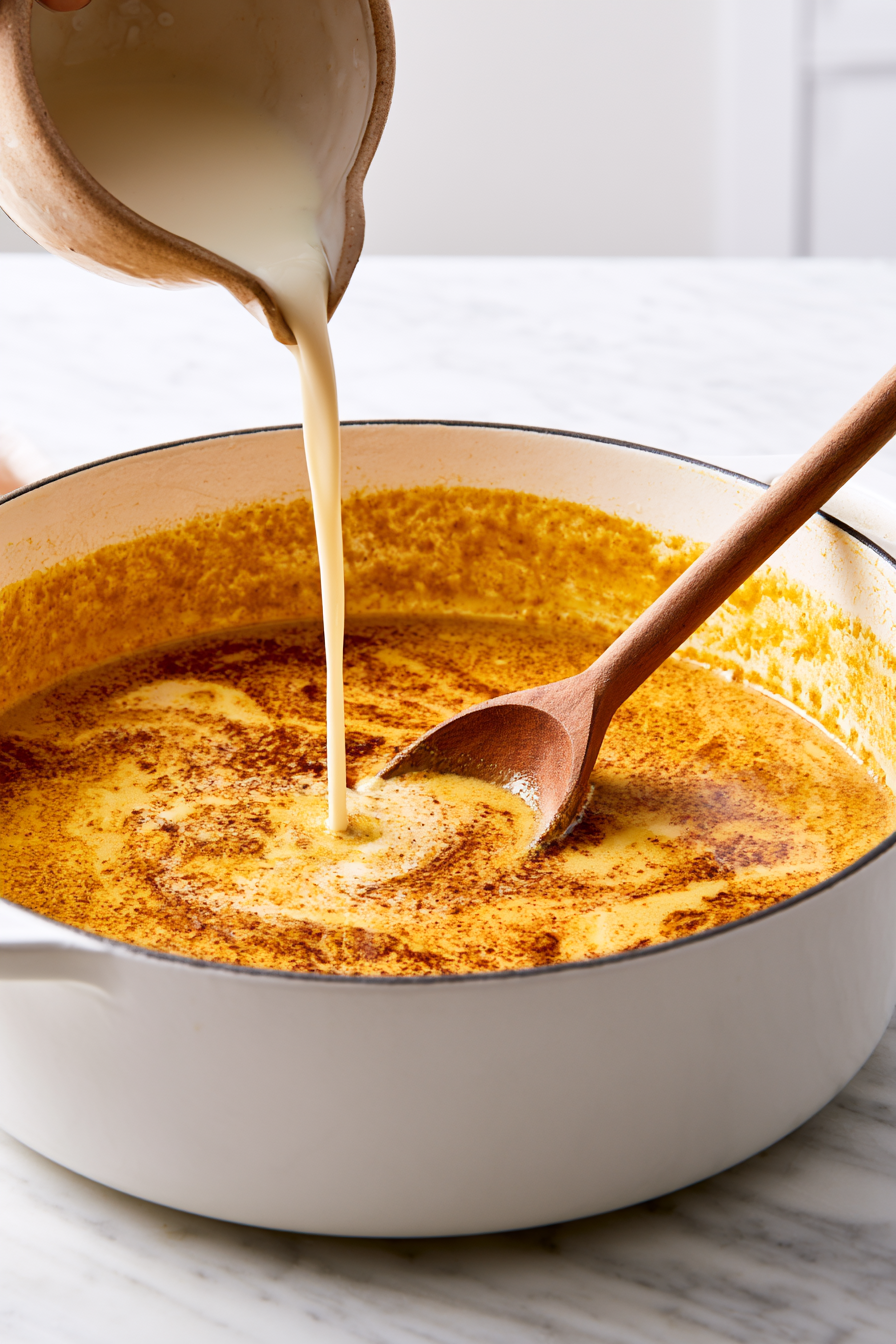 Pour in the coconut milk, vegetable broth, soy sauce, and brown sugar