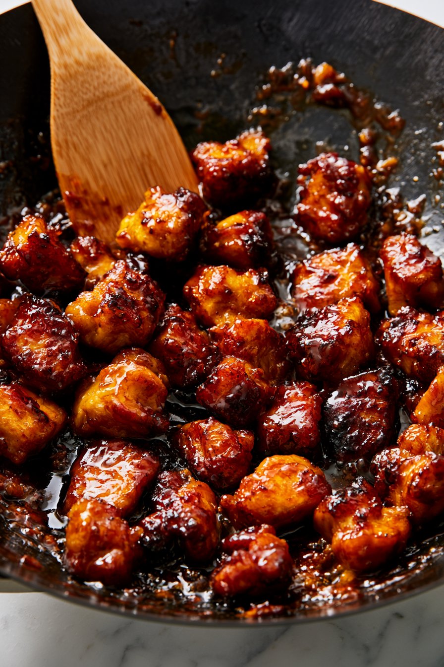 Return the fried chicken to the pan and toss until every piece is evenly coated in the sticky honey garlic sauce