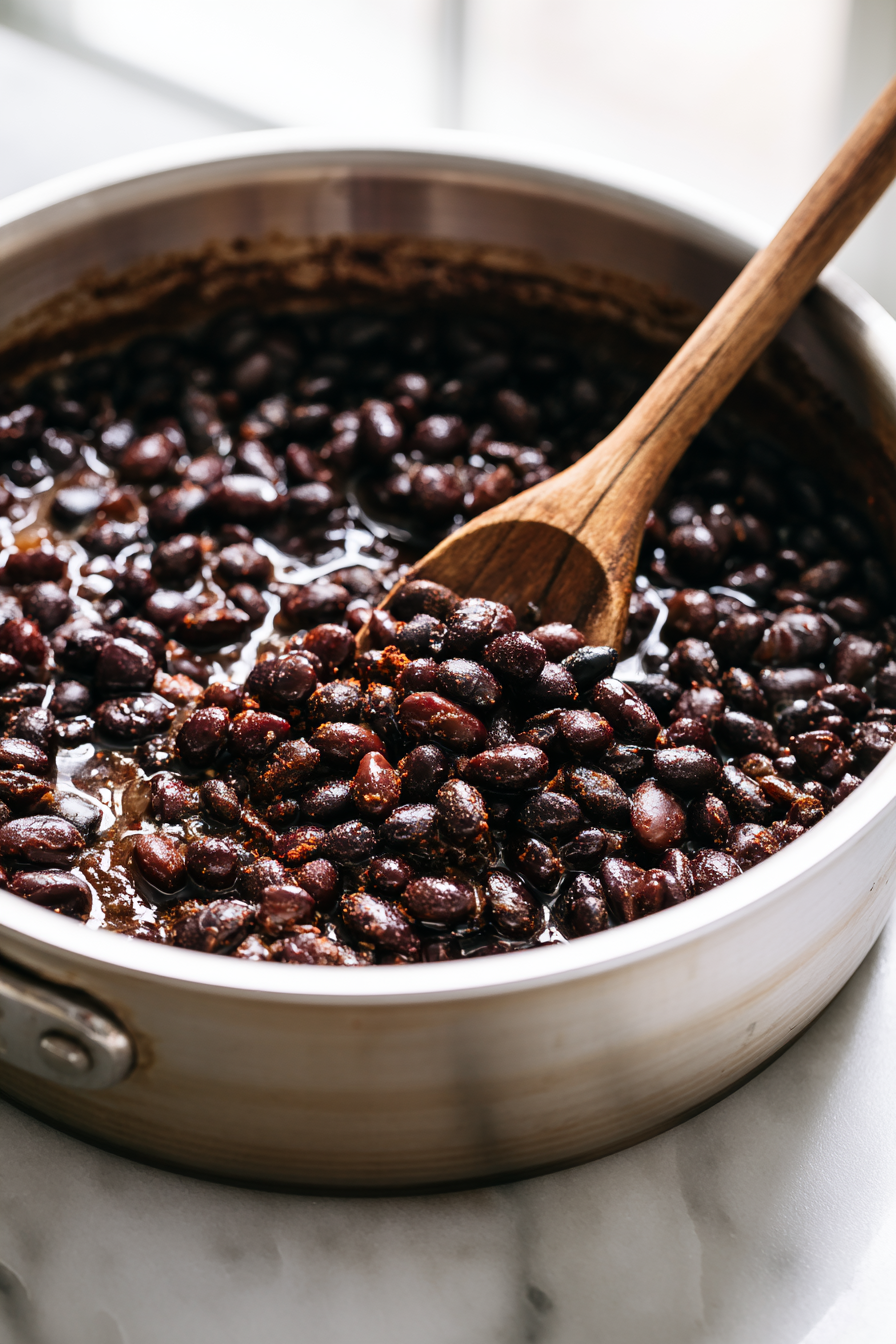 Stir in the cumin, chili powder, and smoked paprika. Add the black beans and vegetable broth, then simmer for 8 to 10 minutes until heated through and lightly saucy