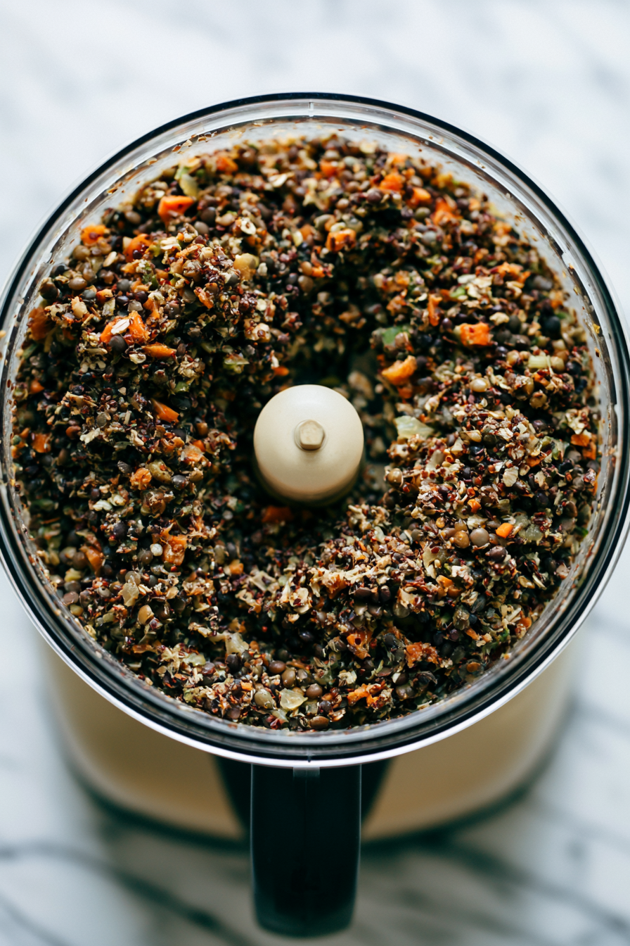 Transfer the cooked lentils, vegetable mixture, oats, and flax mixture to a food processor