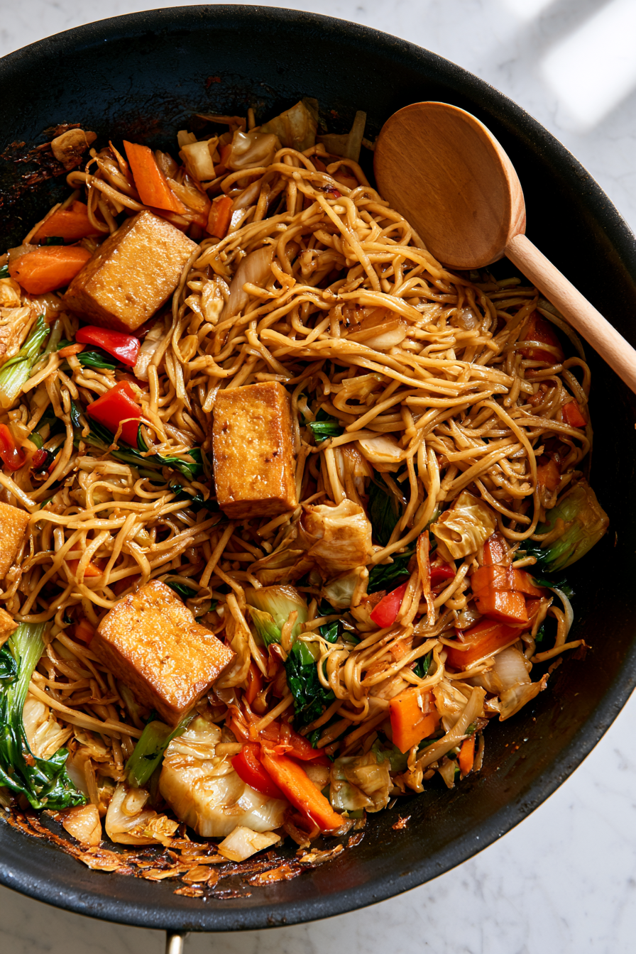 Add the cooked noodles and pour the prepared chow mein sauce over the top. Toss continuously