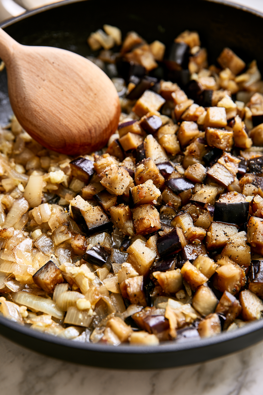 Add the diced eggplant, salt, and black pepper. Cook for 8–10 minutes, stirring occasionally, until the eggplant becomes tender and soft