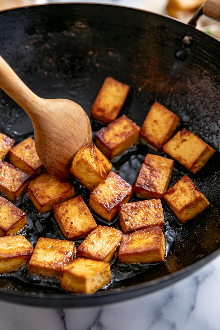 Add the tofu slices or vegan chicken pieces and cook for 5–7 minutes until golden and lightly crisp