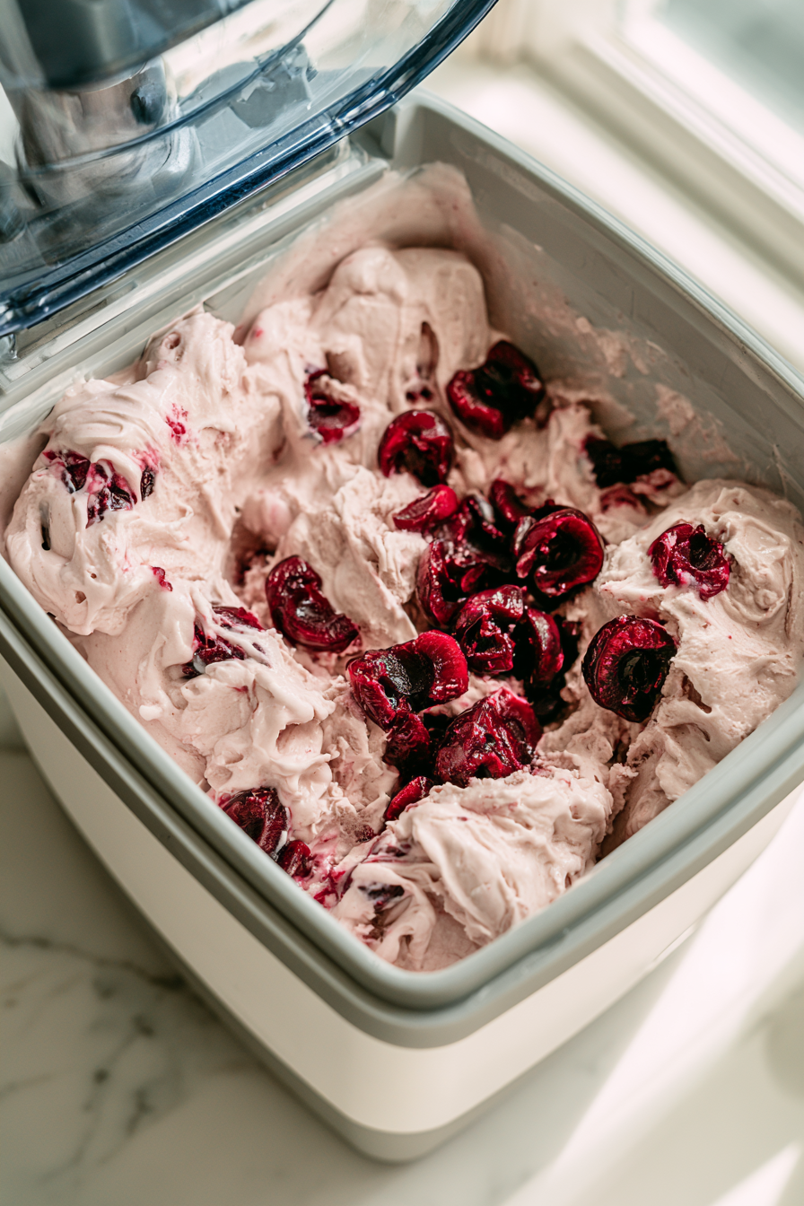 Churn the chilled custard in an ice cream maker according to the manufacturer's instructions. Add the chilled cherries during the final few minutes of churning