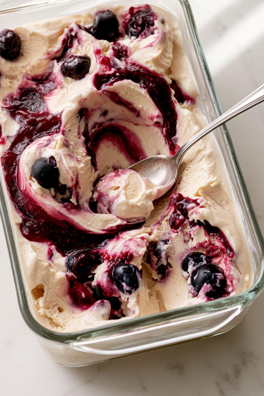 Layer the ice cream and cherry jam in a freezer-safe container, then gently swirl with a knife