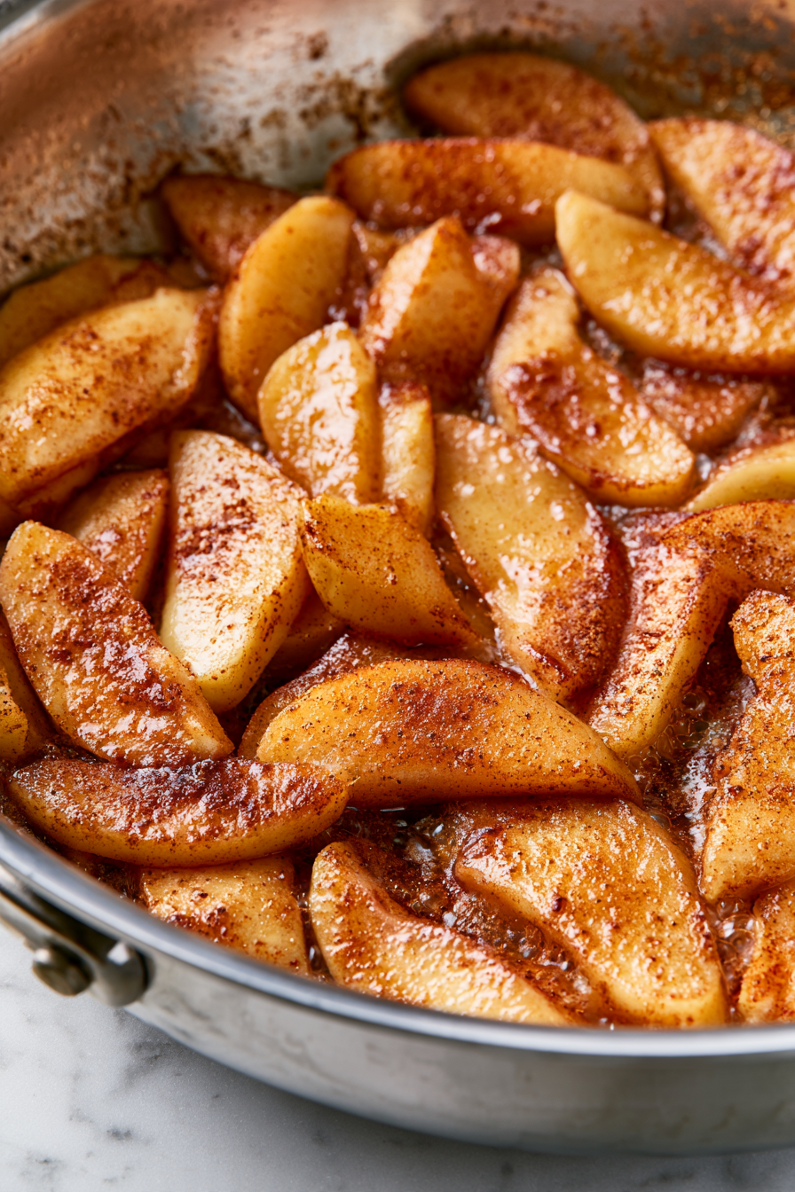 Melt the vegan butter in a large skillet over high heat, then add the apples, brown sugar, flour, cinnamon, ginger, and nutmeg